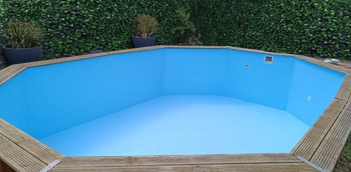 piscine en bois après réalisation de son nouveau revêtement en résine armée de fibre de verre avec gelcoat de finition bleu clair